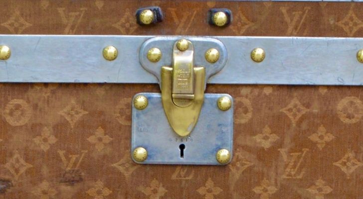 A closeup of a Louis Vuitton trunk lock