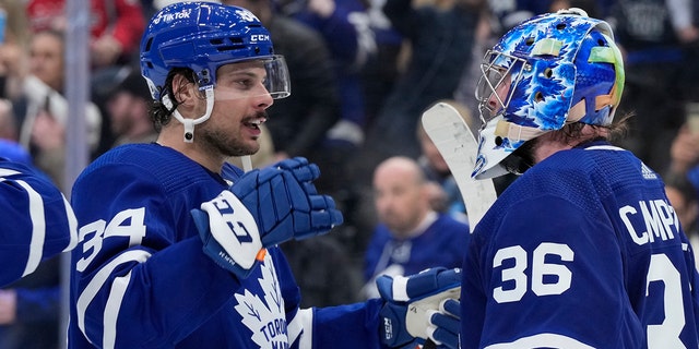 Toronto Maple Leafs center Auston Matthews (34) and goalie Jack Campbell (36) celebrate the team's 7-3 win over the Washington Capitals in an NHL hockey game Thursday, April 14, 2022, in Toronto.